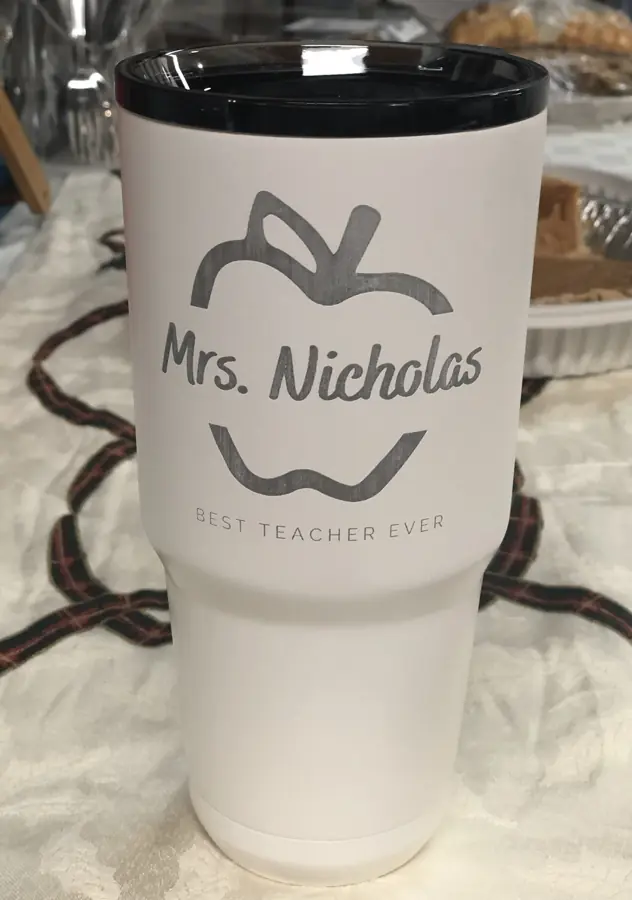 White tumbler engraved with an apple outline and Mrs. Nicholas, Best Teacher Ever