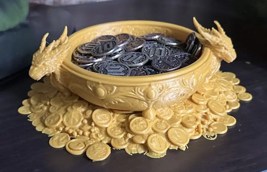Gold 3D-printed dragon dish surrounded by sculpted coins, holding metal coins