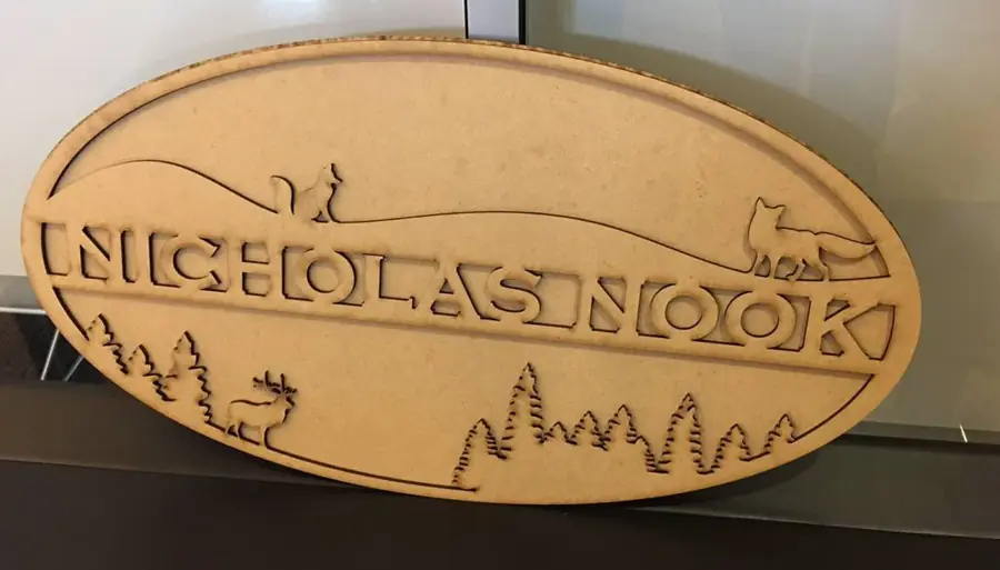 The Nicholas Nook sign fresh off the laser, raw cut wood before painting