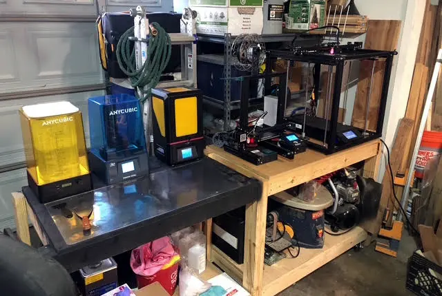 Workbench in the Blackfeather Made shop lined with resin and filament 3D printers